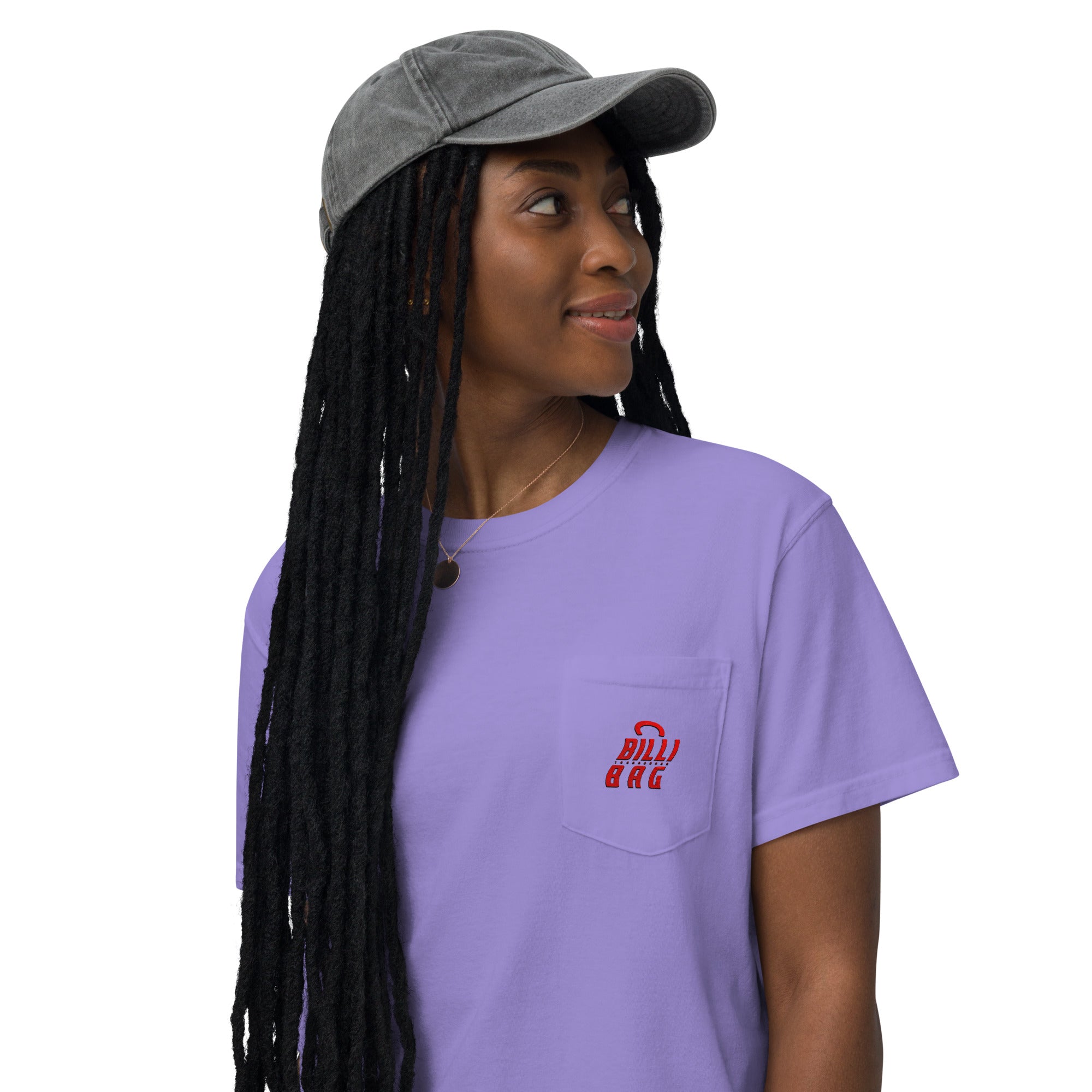 Woman in purple t-shirt with grey cap, looking to the side.