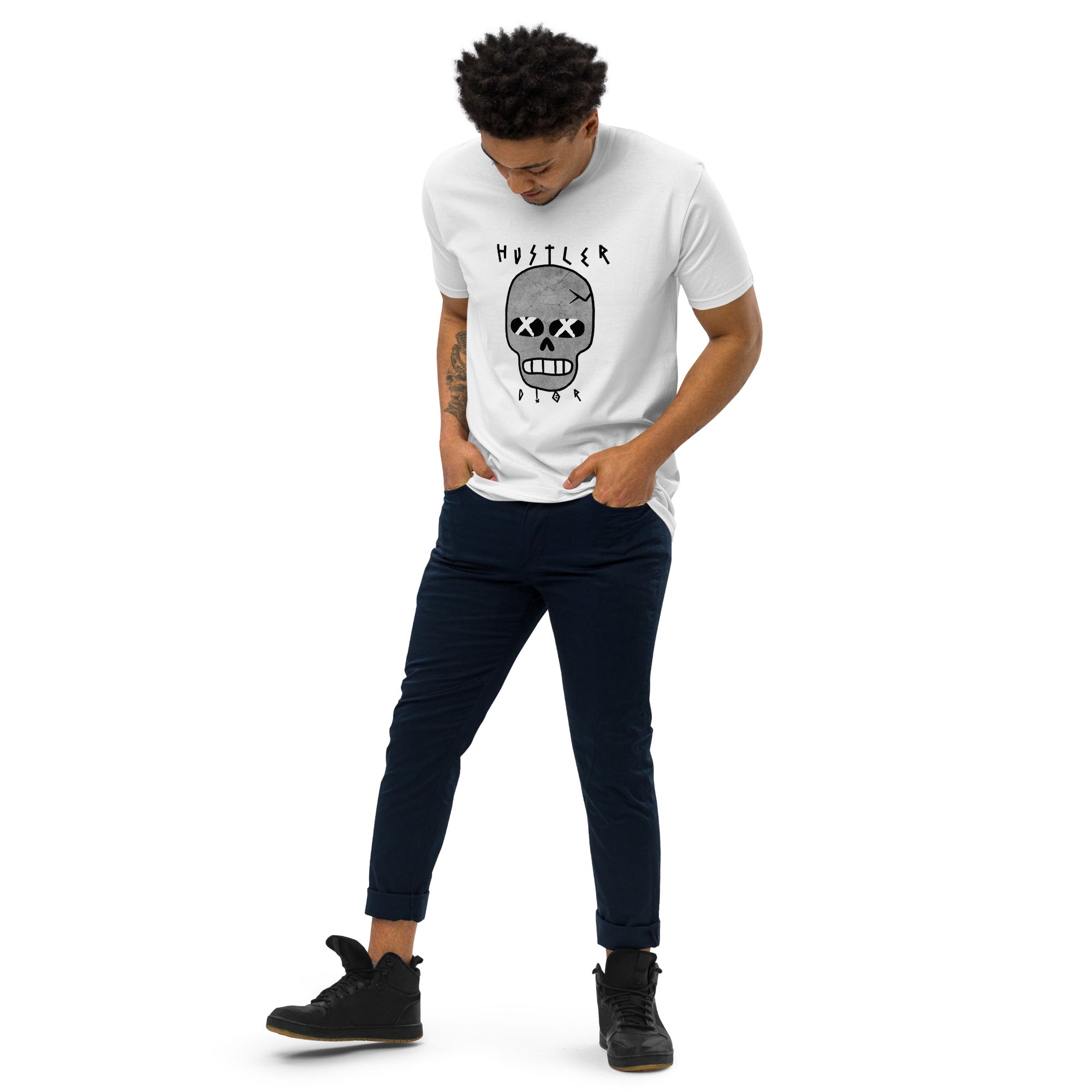 Man in white T-shirt with skull graphic, dark pants, and black shoes.