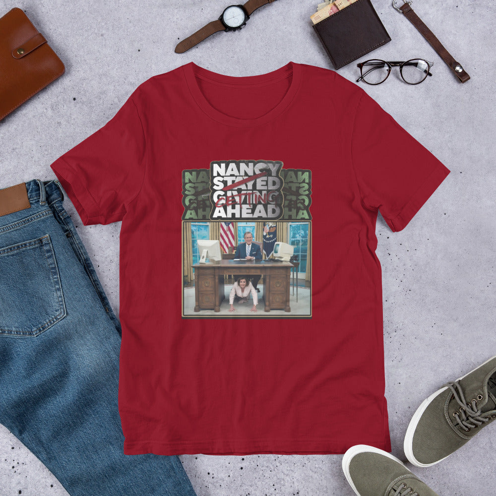 Maroon t-shirt with a graphic image, surrounded by jeans, shoes, and accessories.